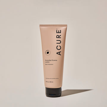 A tube of ACURE Everyday Eczema Lotion against a neutral background.